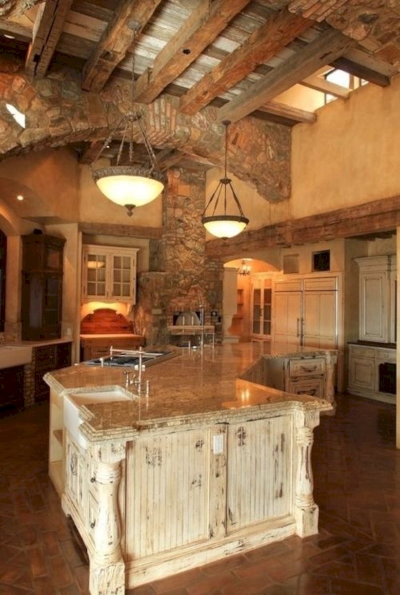 High ceilinged rustic kitchen with stone