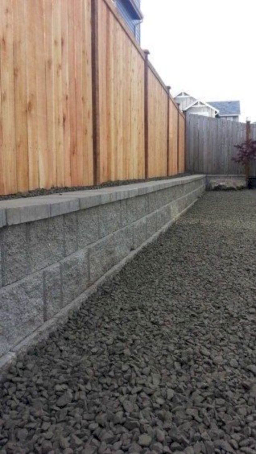 Wooden privacy fence with a cinder block wall