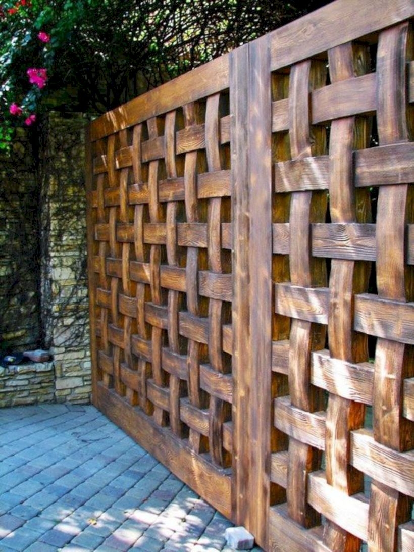 A solid wooden fence in a lattice style