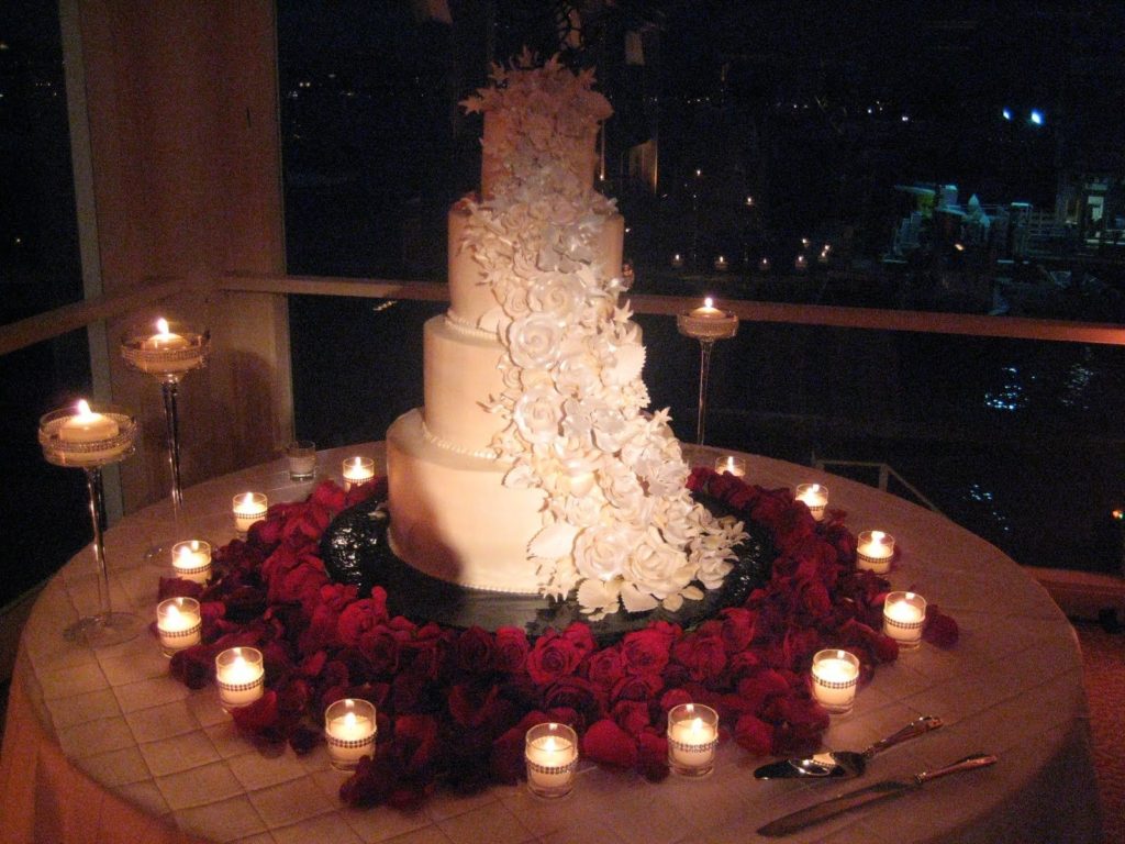 4. red roses, candle, and white cake for dinner