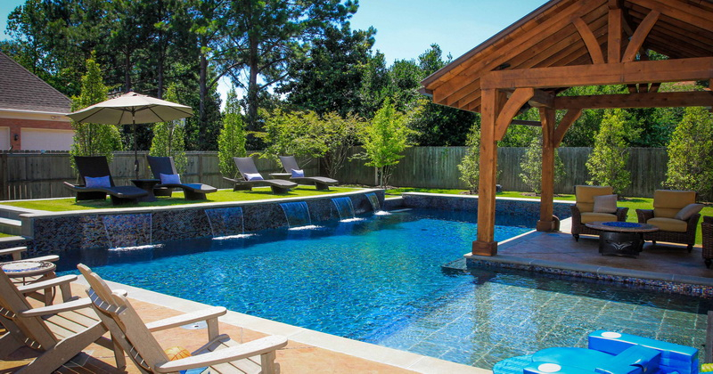 2. combination pool and stone waterfall in backyard