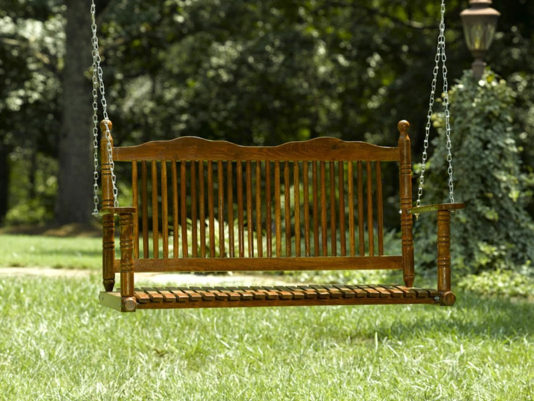 A classic bench seat swing with a finely crafted wood design to complete your summer garden
