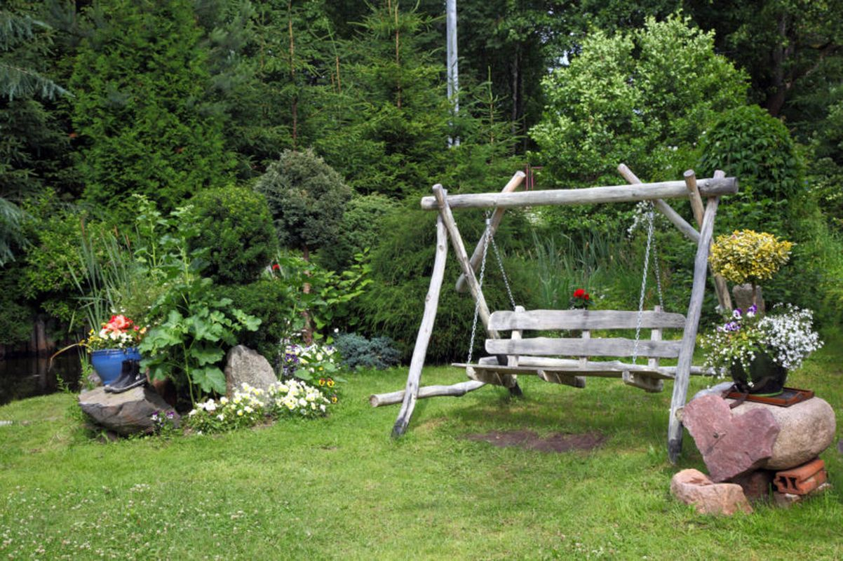 An amazing summer garden with a diy old wood swing to beautify your backyard