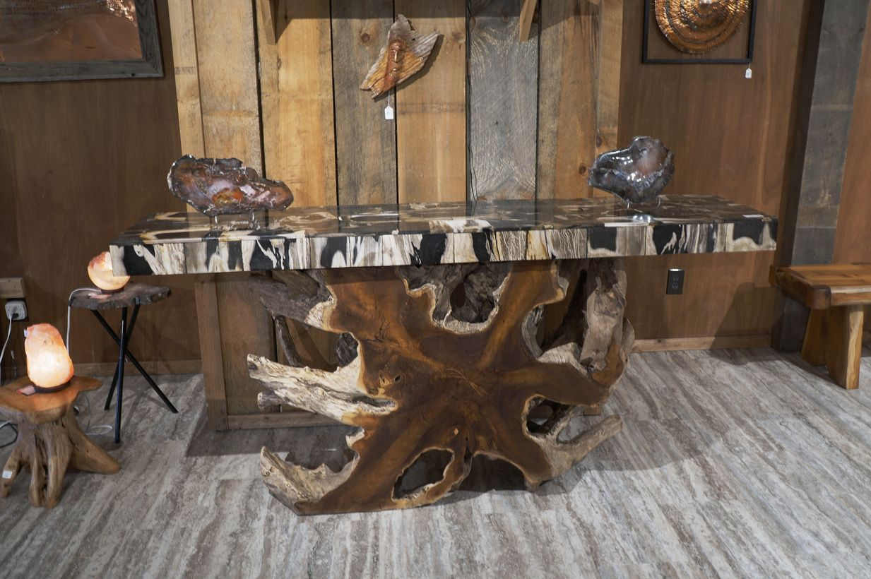 An interesting teak wood furniture with a wooden table, wooden walls, wooden roof and wooden chairs