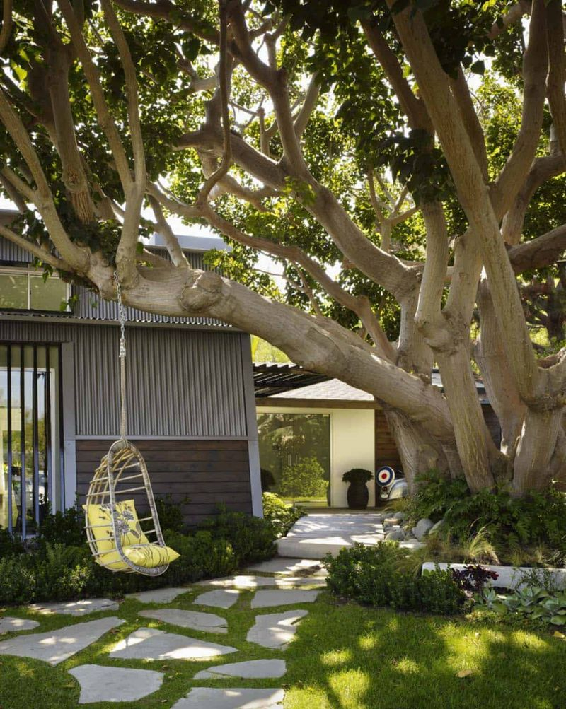 Cozy garden ideas for summer with swing has a rattan body and yellow cushions