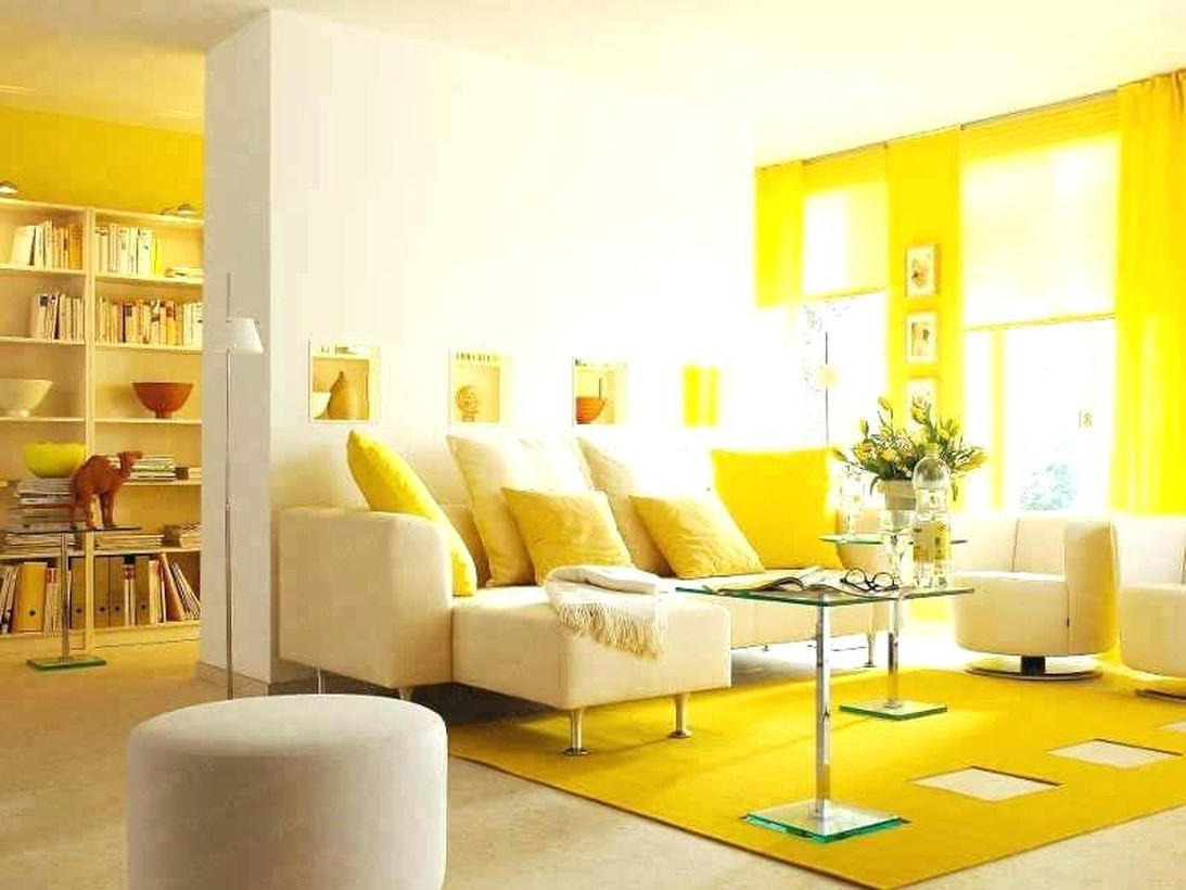 Gorgeous yellow living room with yellow carpet, yellow curtains, yellow pillows, brown sofa, small table, big window