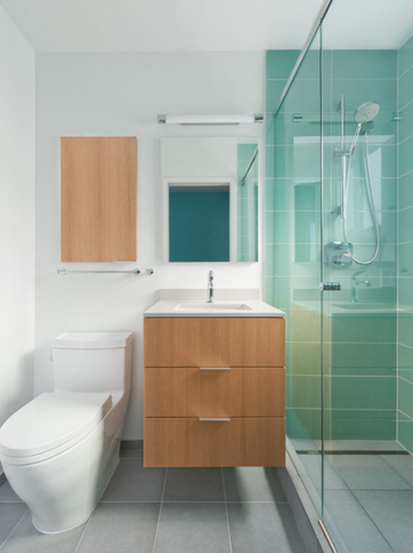 Modern bathroom design with clean shades of blue, towel hooks, a sink and drawers on below, a square mirror
