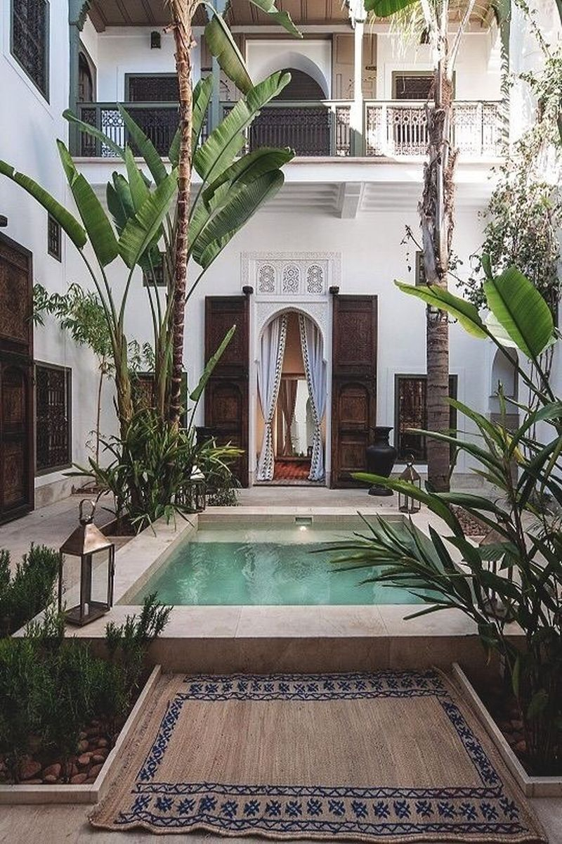 Modern exterior design with small pool, white walls, palm decoration, white curtain on the door to beautify your boho home