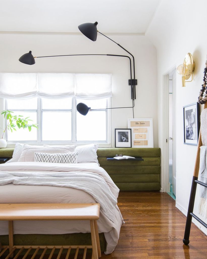 A modern farmhouse bedroom design with a wooden night stand on beside, wooden vinyl floor, big windows, and decorative lighting to create perfect lighting