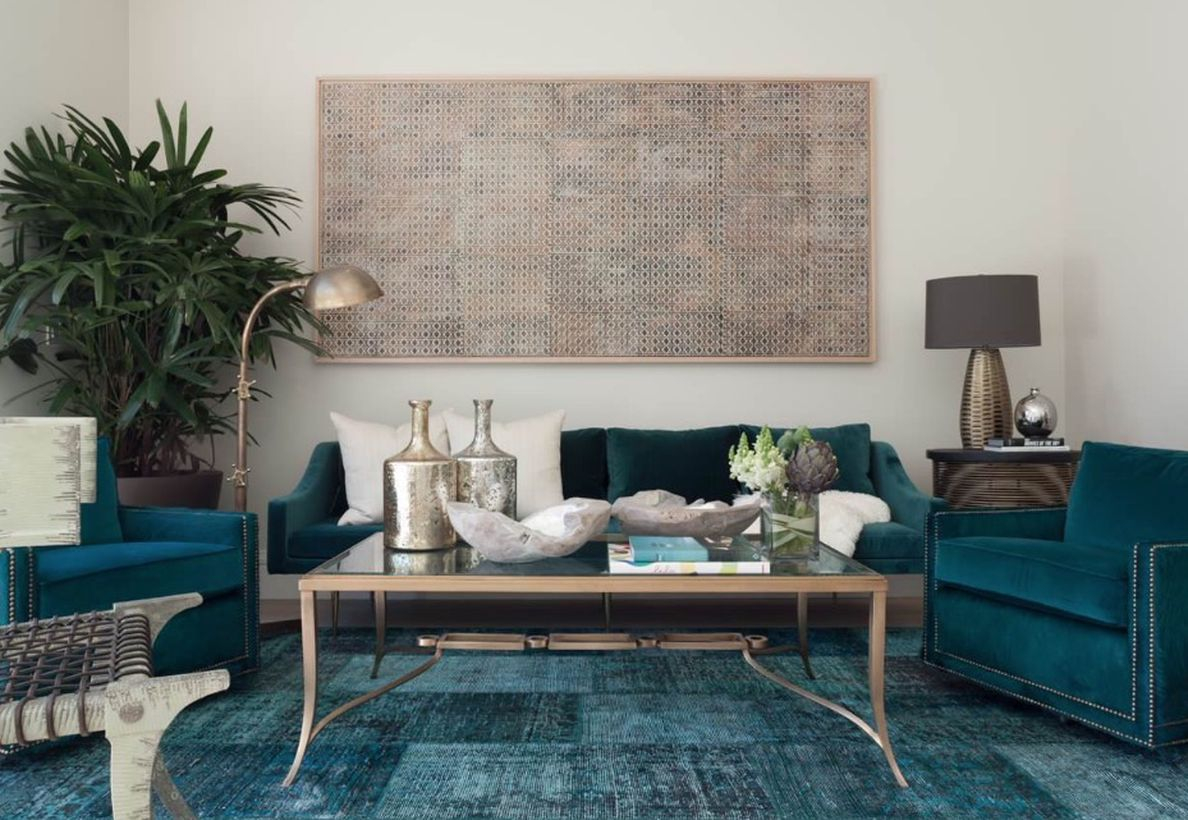 A stunning living room monochrome color design with white walls, black and white sofa cushions, a metal layer coffee table, a house plant at the corner, and table lamp