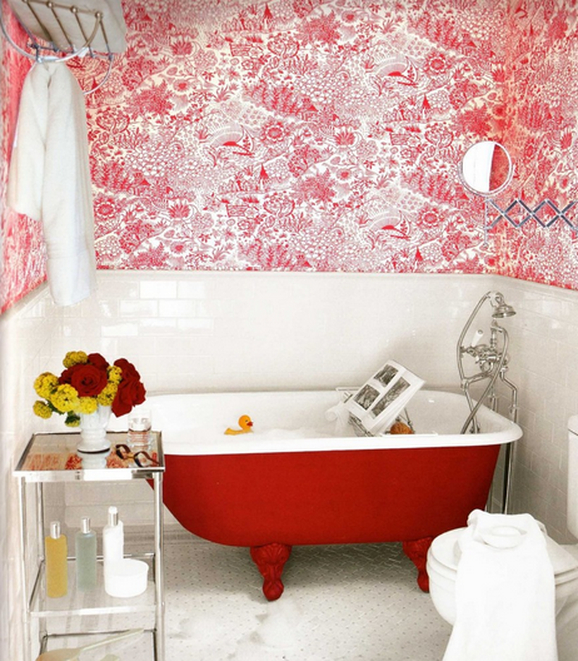 A unique small bathroom decor ideas with red wallpaper, and brick ceramic walls, a red and white bathtub, a towel hook, small metal table to put some toiletries and a house plant