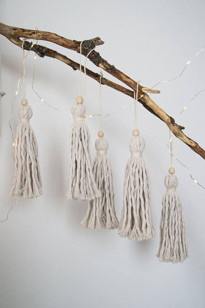 A stylish natural ornament elements for summer with Tassels made of cotton ropes that are not used are bleached with beads and small wooden twigs