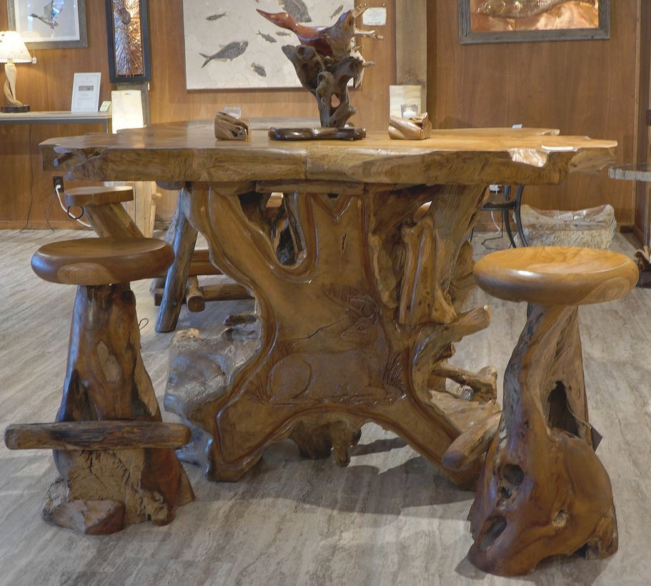 An attractive small teak wood furniture with round wooden table, wooden chairs, wooden floor and wooden walls