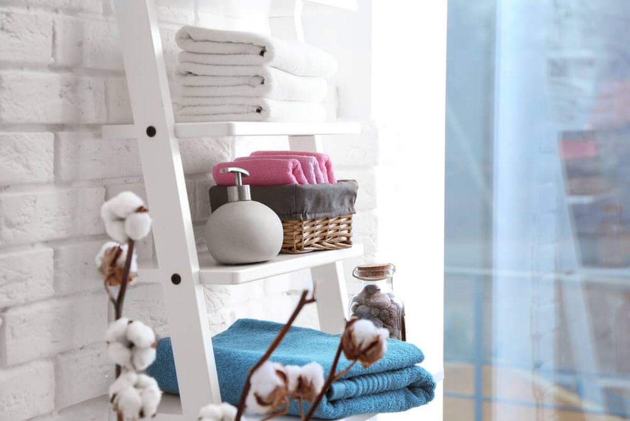 Creative storage bathroom with a white ladder to store toiletries