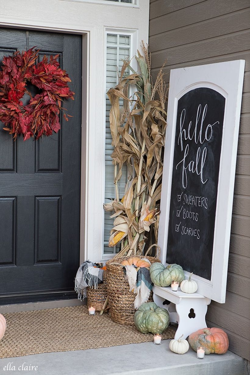 An amazing porch ideas fall welcome signs with wooden white whiteboard, pumpkins,candle lights, and red wreath