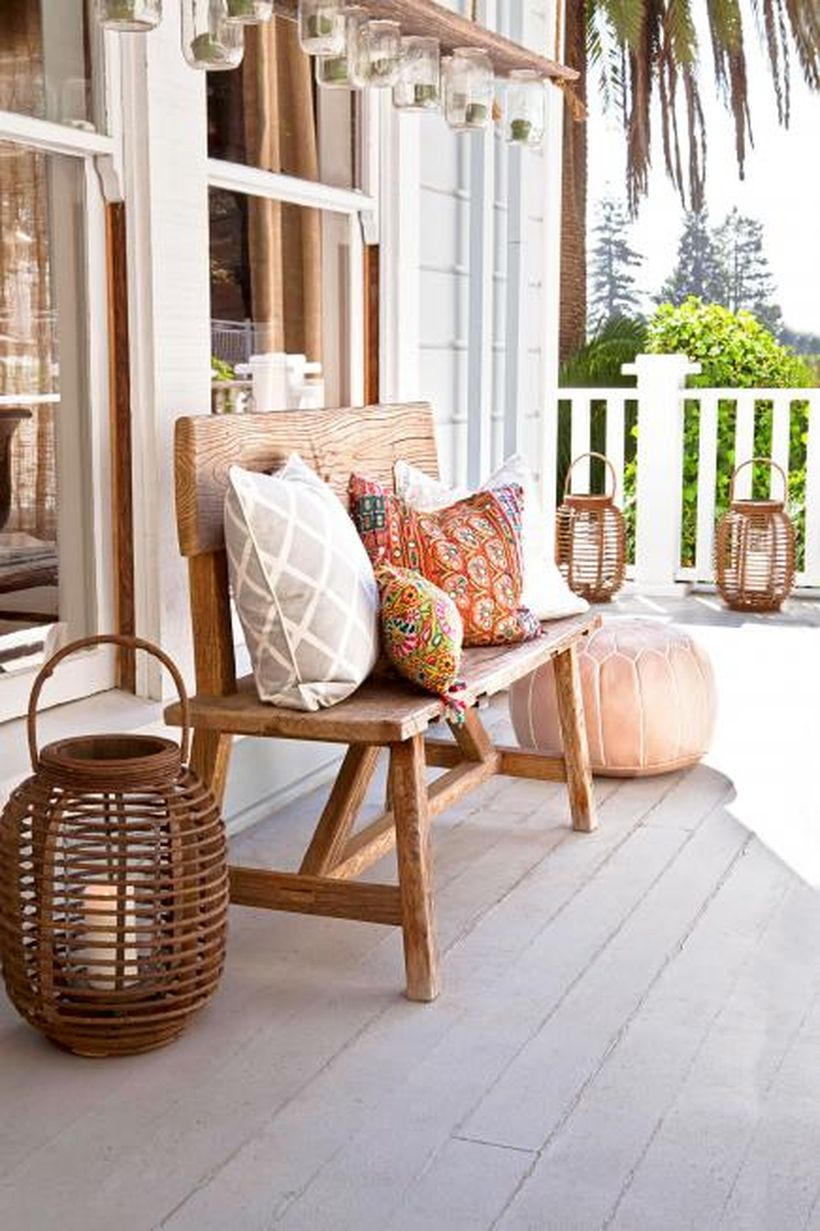 An awesome seating ideas with a wooden chair, candle lights from rattan and pillows
