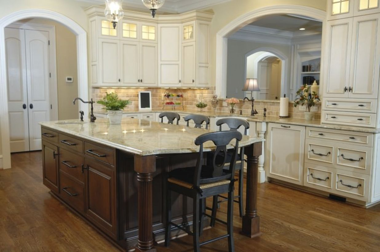 An impressive home paint colors with beige kitchen room, arched doorway, central island breakfast bar and hardwood flooring