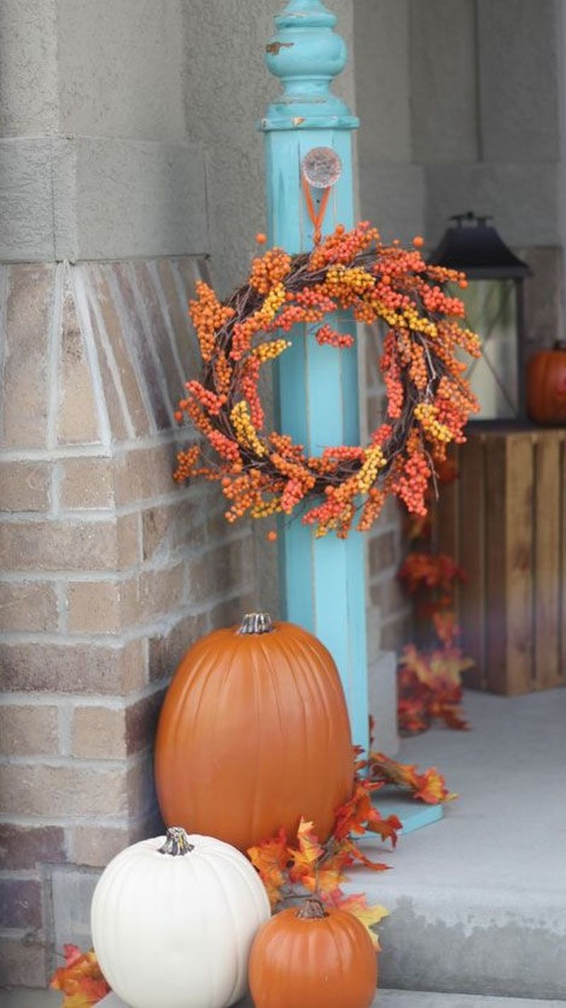 Beautiful outdoor decoration for fall combine with a bountiful fall wreath and faux pumpkins