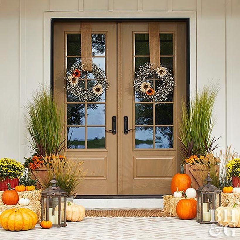 Interesting farmhouse porch ornament with plants in square wooden pot , pumpkins and candle lights