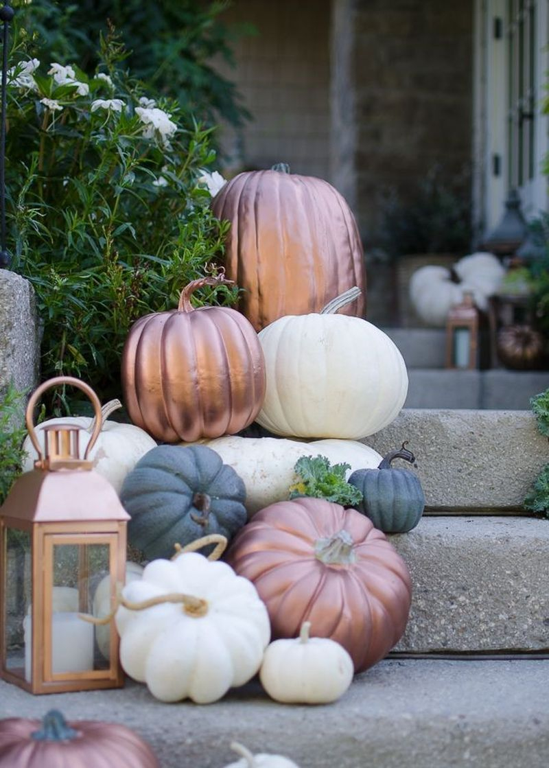 Pumpkins cascades of copper, off-white, and gray to combine with lanterns to brighten up your front stair in this fall
