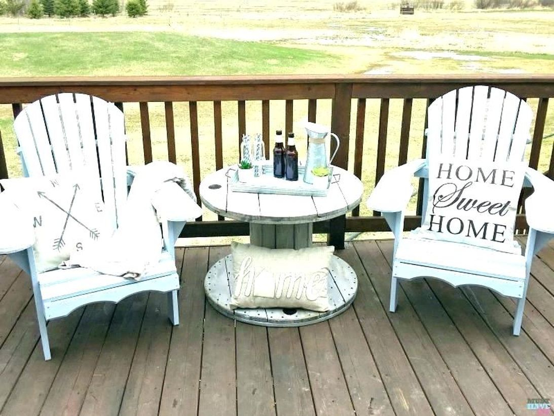 Simple farmhouse porch furniture with blue wooden chairs and small blue round table to create your front yard more comfortable