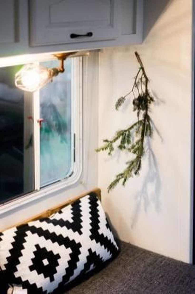 Simple rv decor with piece fresh pine leaves, pendant lamps and pillow motifs