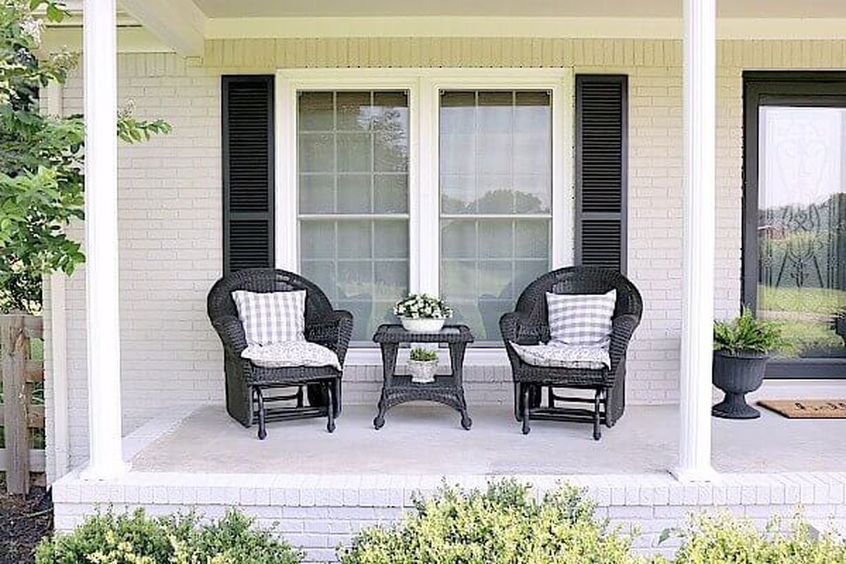 Simple-summer-farmhouse-porch-best farmhouse porch furniture with black rattan chairs and small square black table
