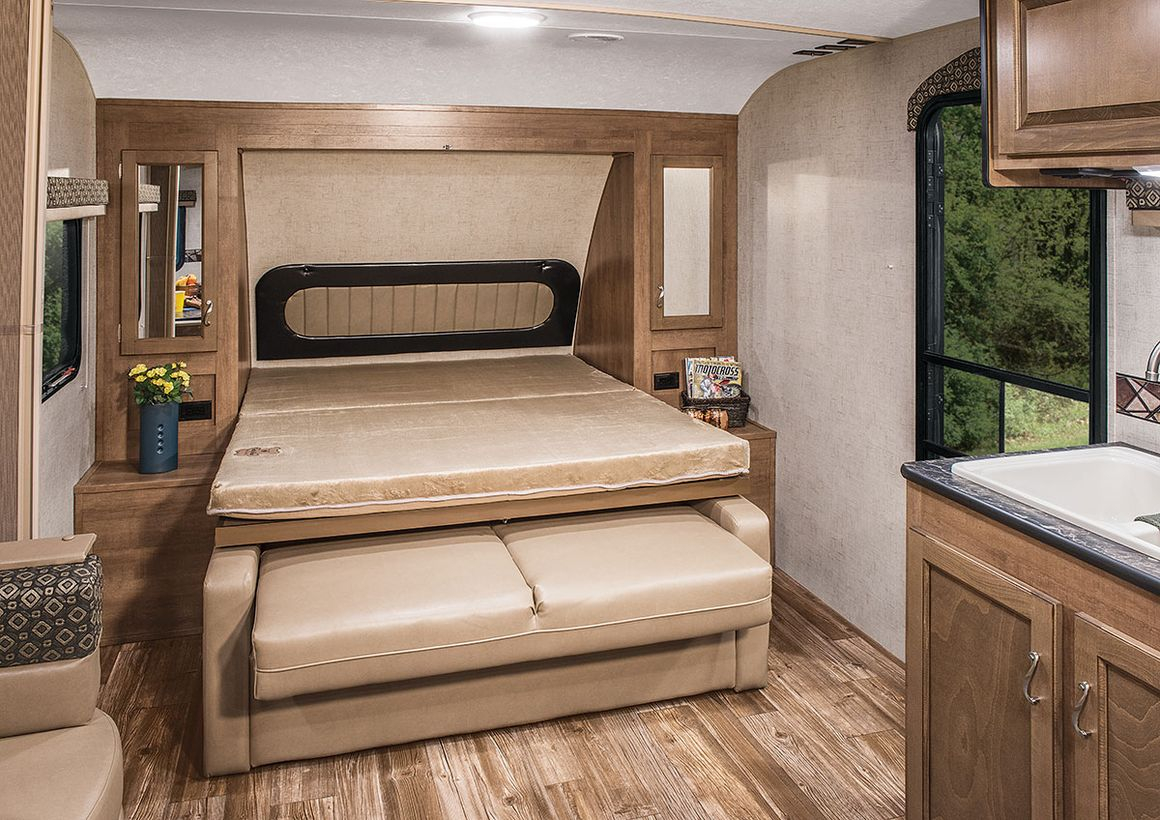 Simple murphy bed with beige color, beige sofa under the bed and wooden storage cabinet