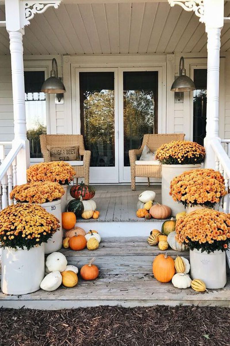 Use fresh flowers and lots of little gourds to beautify your front stair in this fall