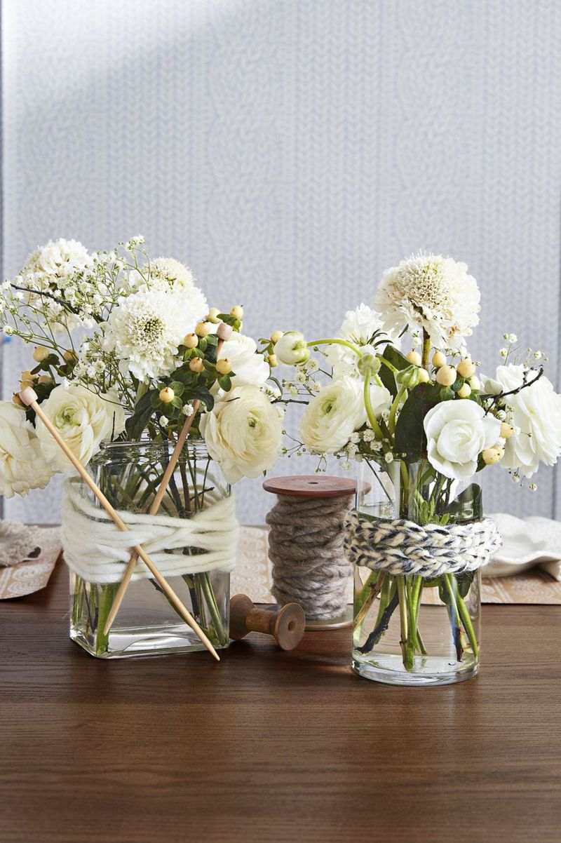 Vintage spools of assorted heights, wool yarn, and some leftover knitting needles to recreate this wonderfully unique centerpiece arrangement