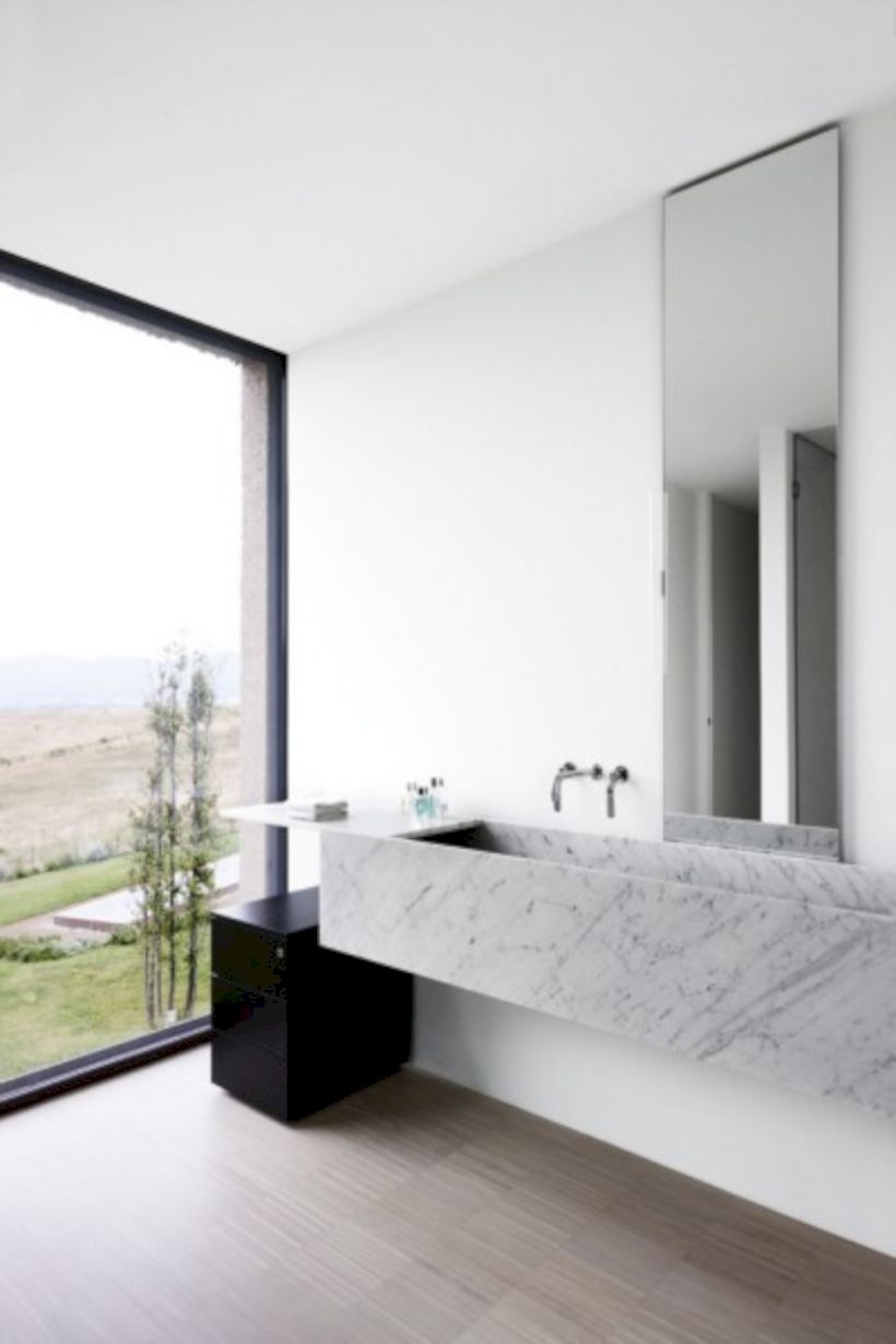 Nice and minimalist bathroom with the glass wall with a concrete 07