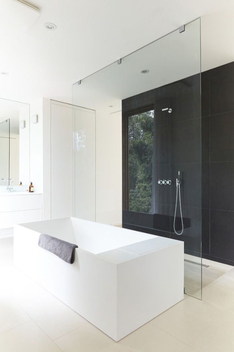 Nice and minimalist bathroom with the glass wall with a concrete 17