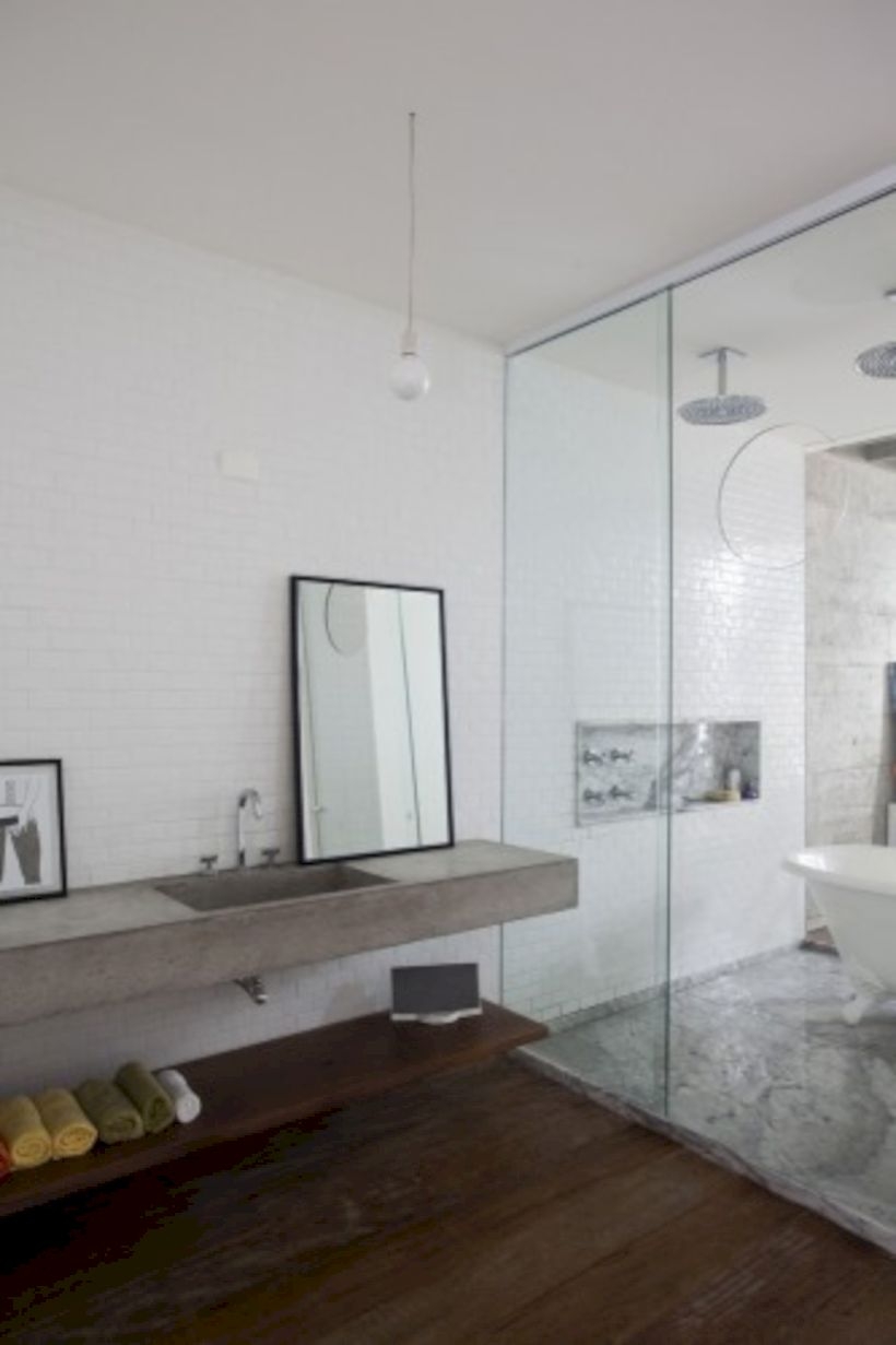 Nice and minimalist bathroom with the glass wall with a concrete 18