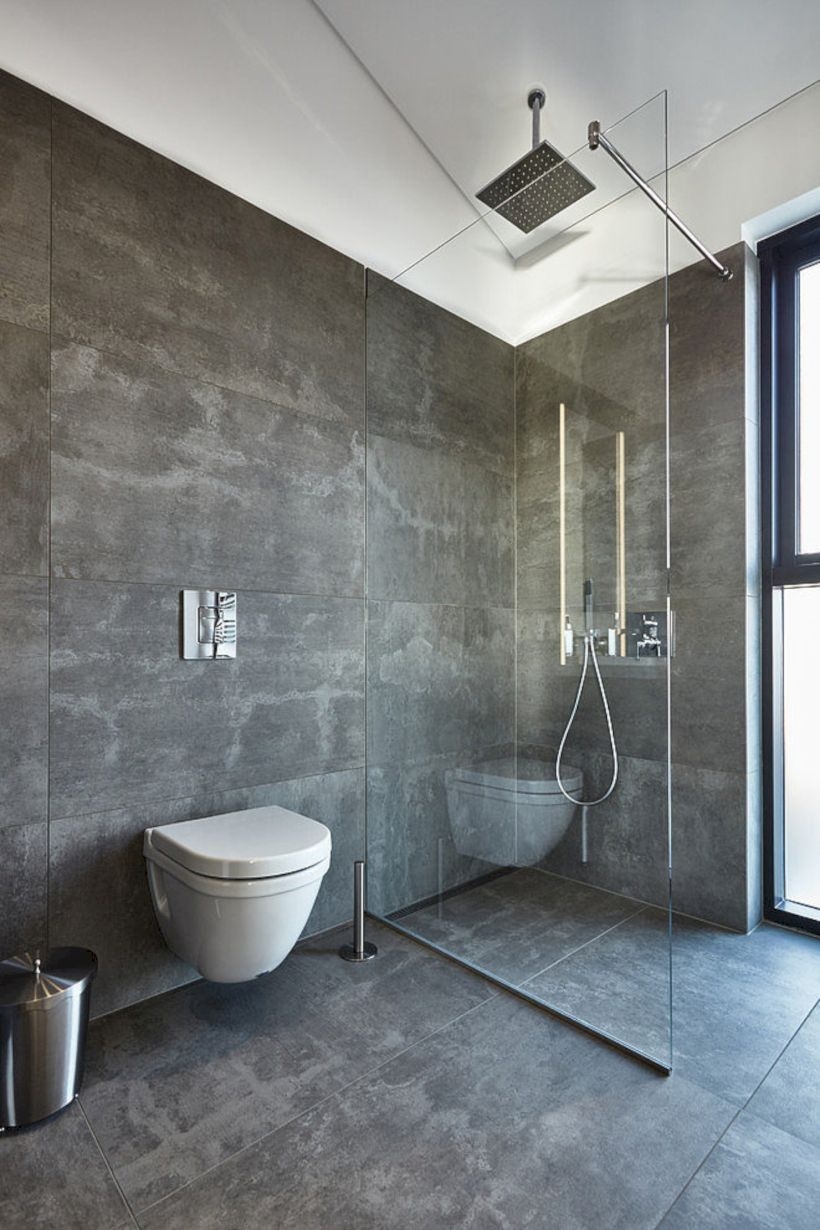 Nice and minimalist bathroom with the glass wall with a concrete 23