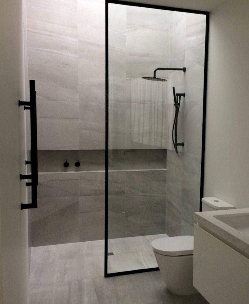 Nice and minimalist bathroom with the glass wall with a concrete 34