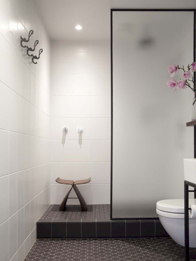 Nice and minimalist bathroom with the glass wall with a concrete 39