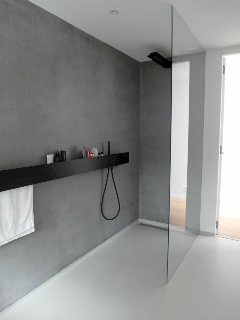Nice and minimalist bathroom with the glass wall with a concrete 40
