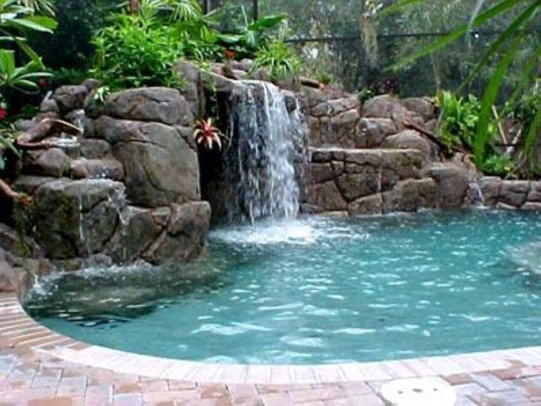 Pool waterfalls ideas for your outdoor space 14