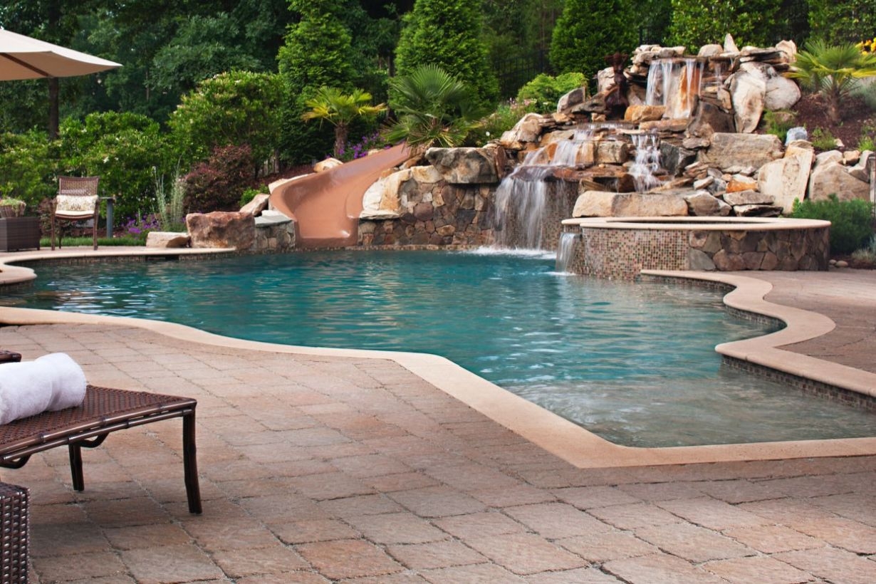 Pool waterfalls ideas for your outdoor space 26