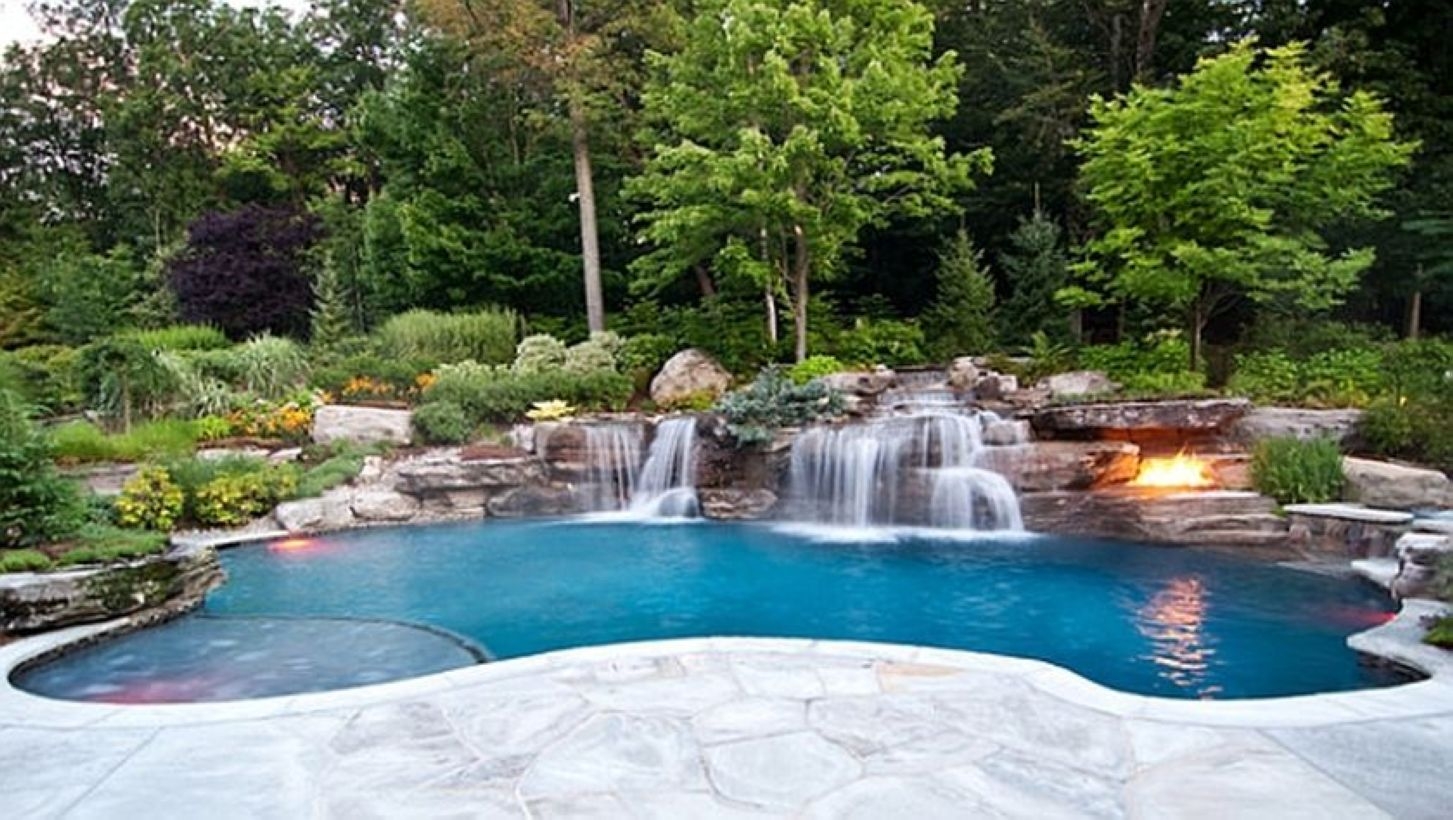 Pool waterfalls ideas for your outdoor space 36