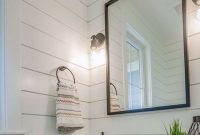 Farmhouse bathroom shiplap paneling white oak vanity concrete countertop with integrated sink and metal mirror