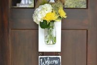 Mason jar flowers on a welcome sign