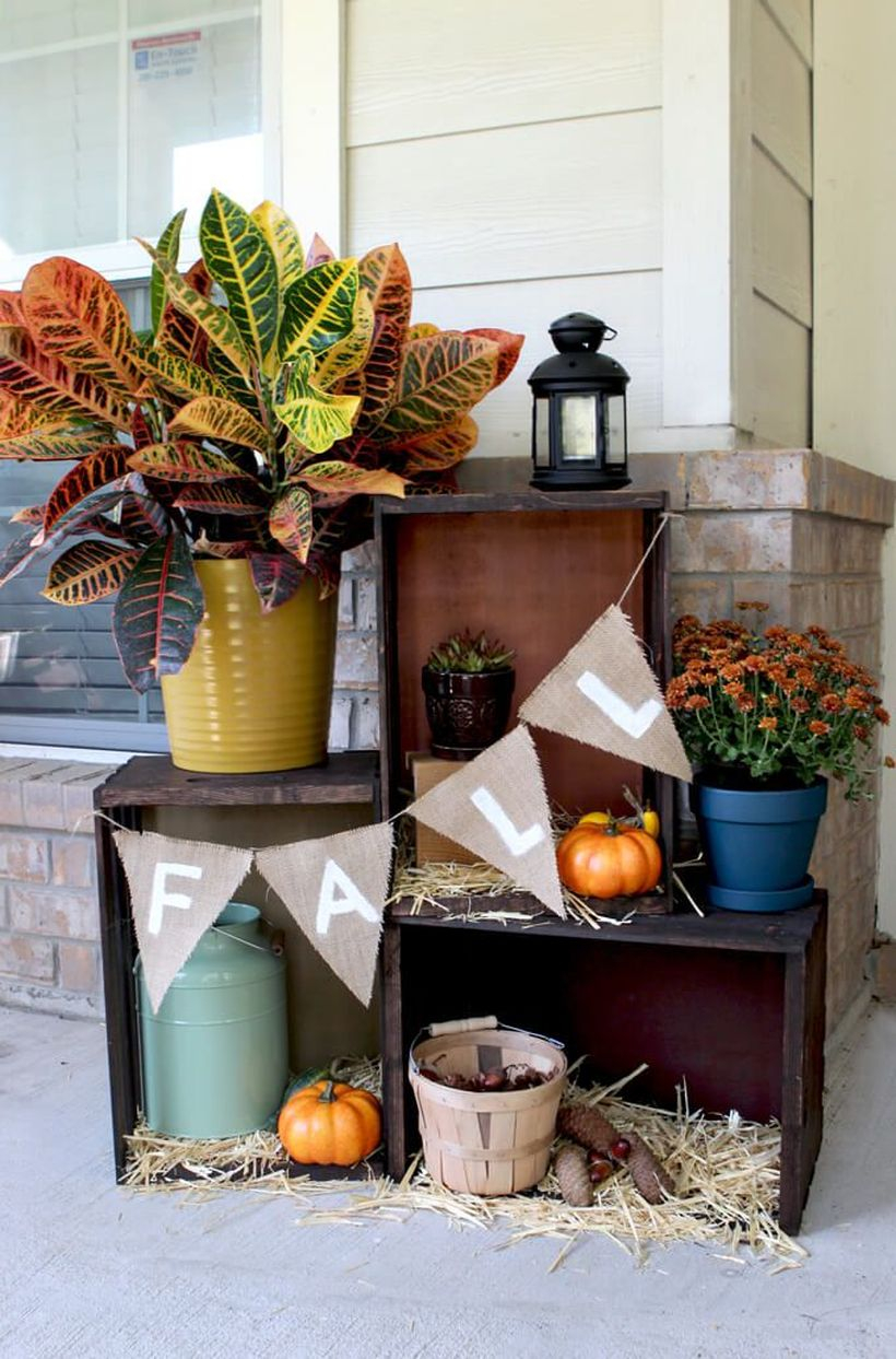 A beautiful outdoor redecoration from summer to fall with pumpkin terraces, piled up several wooden crates, then line with the bottom with hay.
