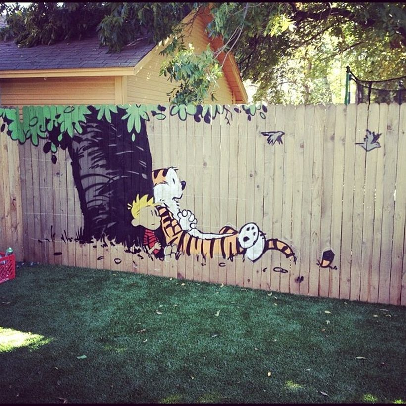 A creative painting fence for garden with calvin and hobbes murals that like the idea of scenes from childhood favorites played in the backyard.
