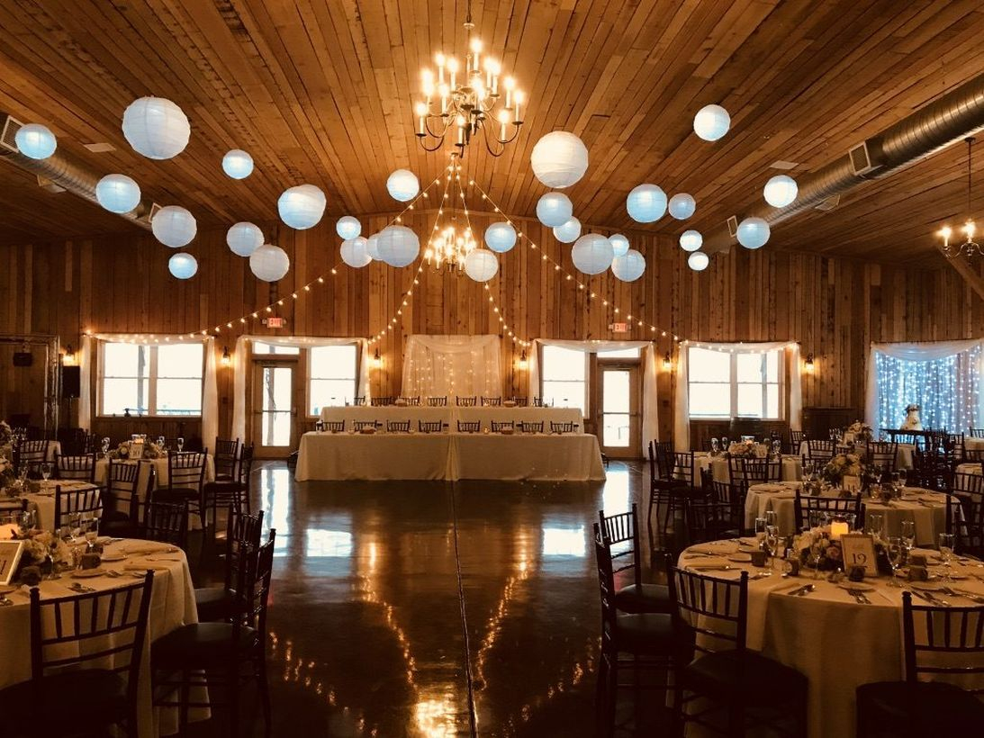A fabulous indoor venue for fall wedding with 100-year-old reclaimed barn wood and sparkling chandeliers give.