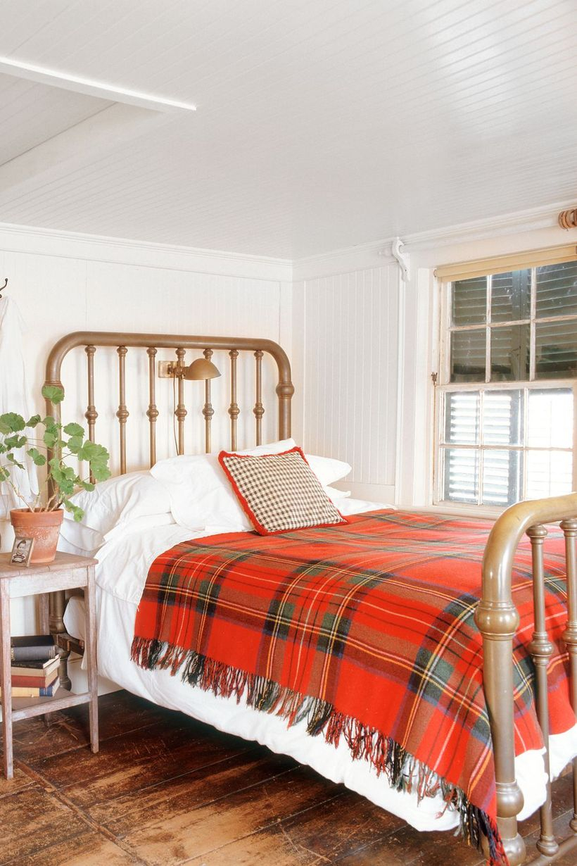 An amazing indoor redecoration from summer to fall with a plaid blanket featuring red, orange, and golden hues that add warmth to your bedroom.