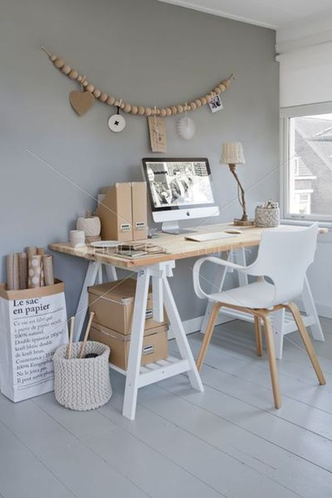 An amazing light subtle grey wall combined with wooden table and wall decoration to complete your neutral office home