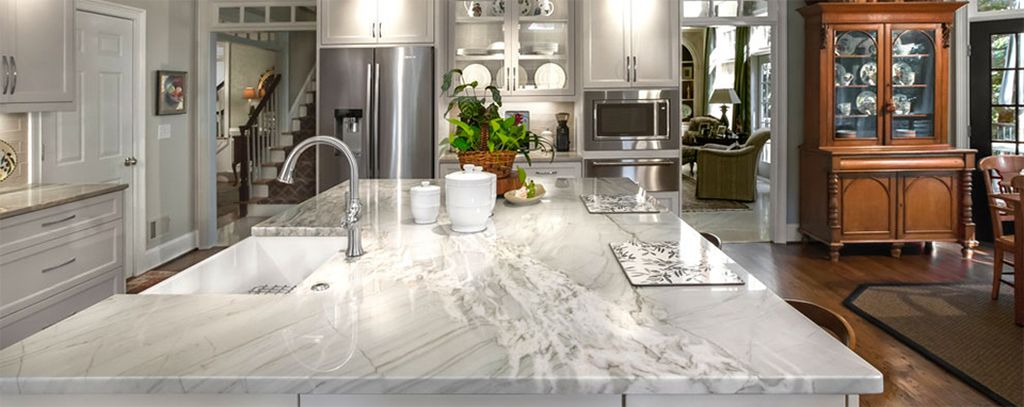 An amazing white granite kitchen countertops combined with wooden floor and plants decoration to complete your modern kitchen