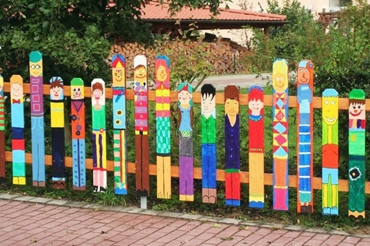 An attractive painting fence for garden with brightly coloured fence people made a whole range of fun looking individuals in all different painting styles.