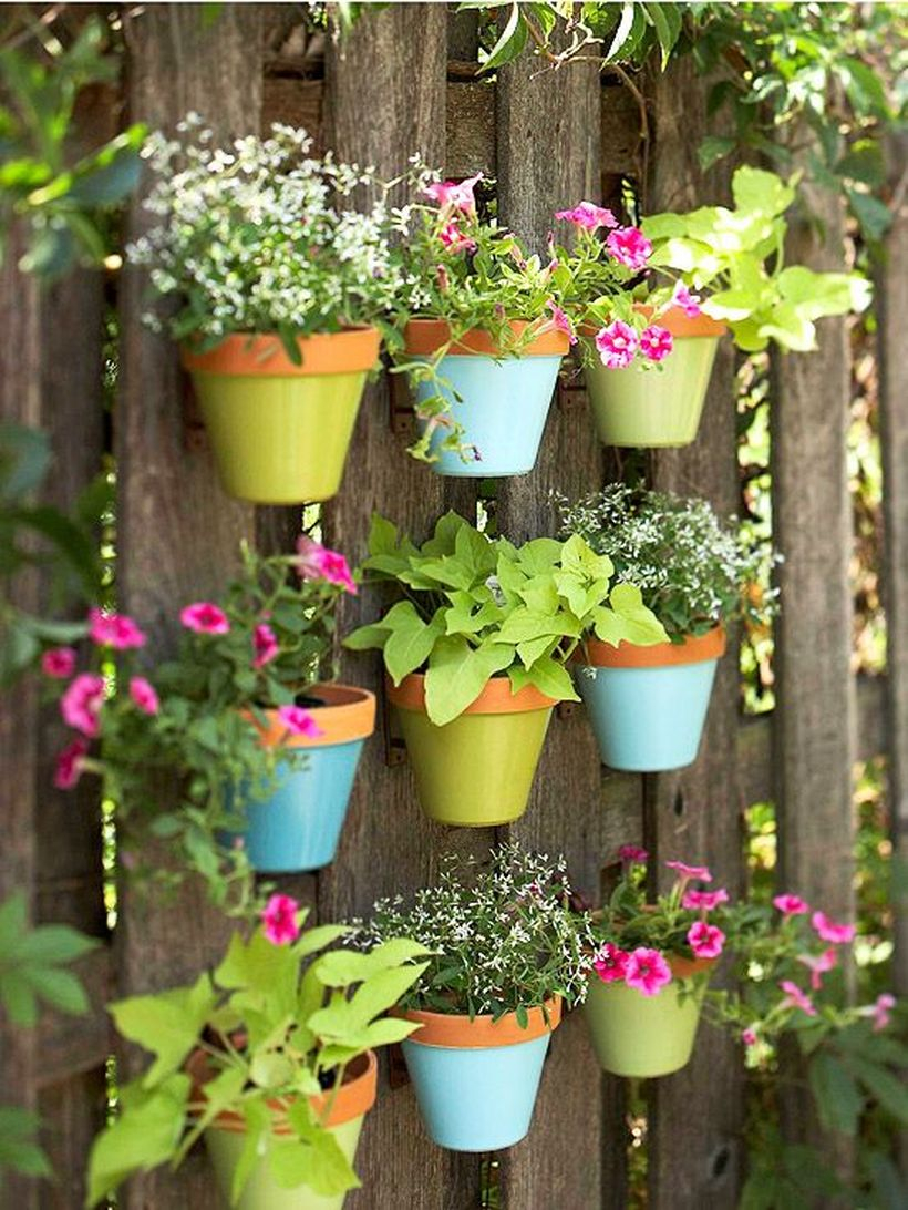 An awesome plant decoration for garden with terra cotta plant hangers that fence will come alive all the plants that you put in this is also a great project for those broken or chipped pots.